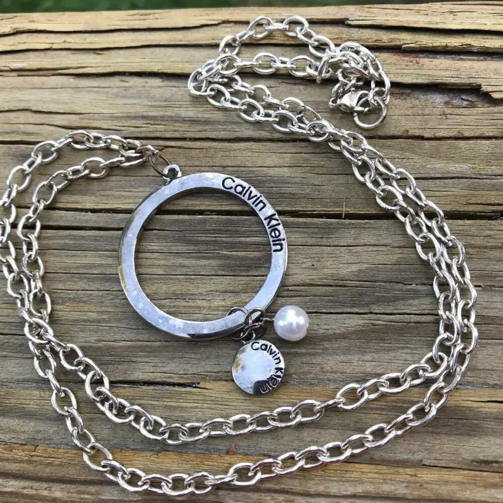 Calvin Klein branded large circle dangle faux pearl accent pendant necklace